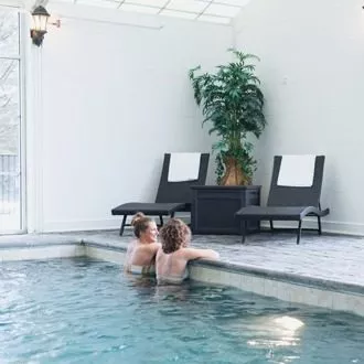 Two women enjoying an indoor pool