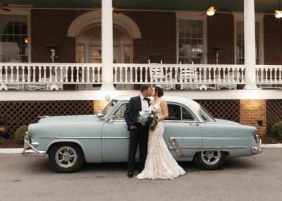 Wedding couple in front of vintage car