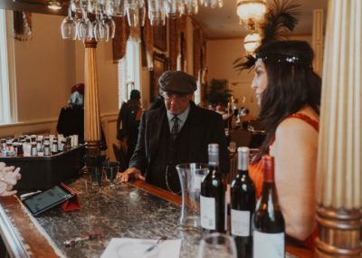 Wine bar with man and woman dressed in 1930s style clothing